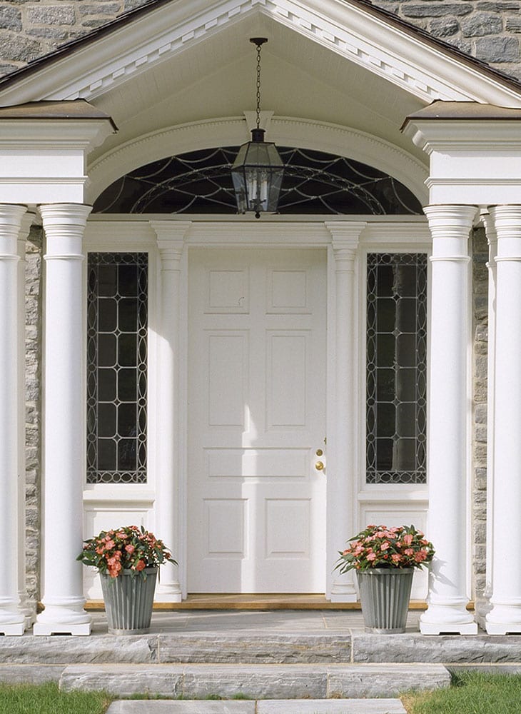 Wooden panel entry door with leaded glass overlay sidelites