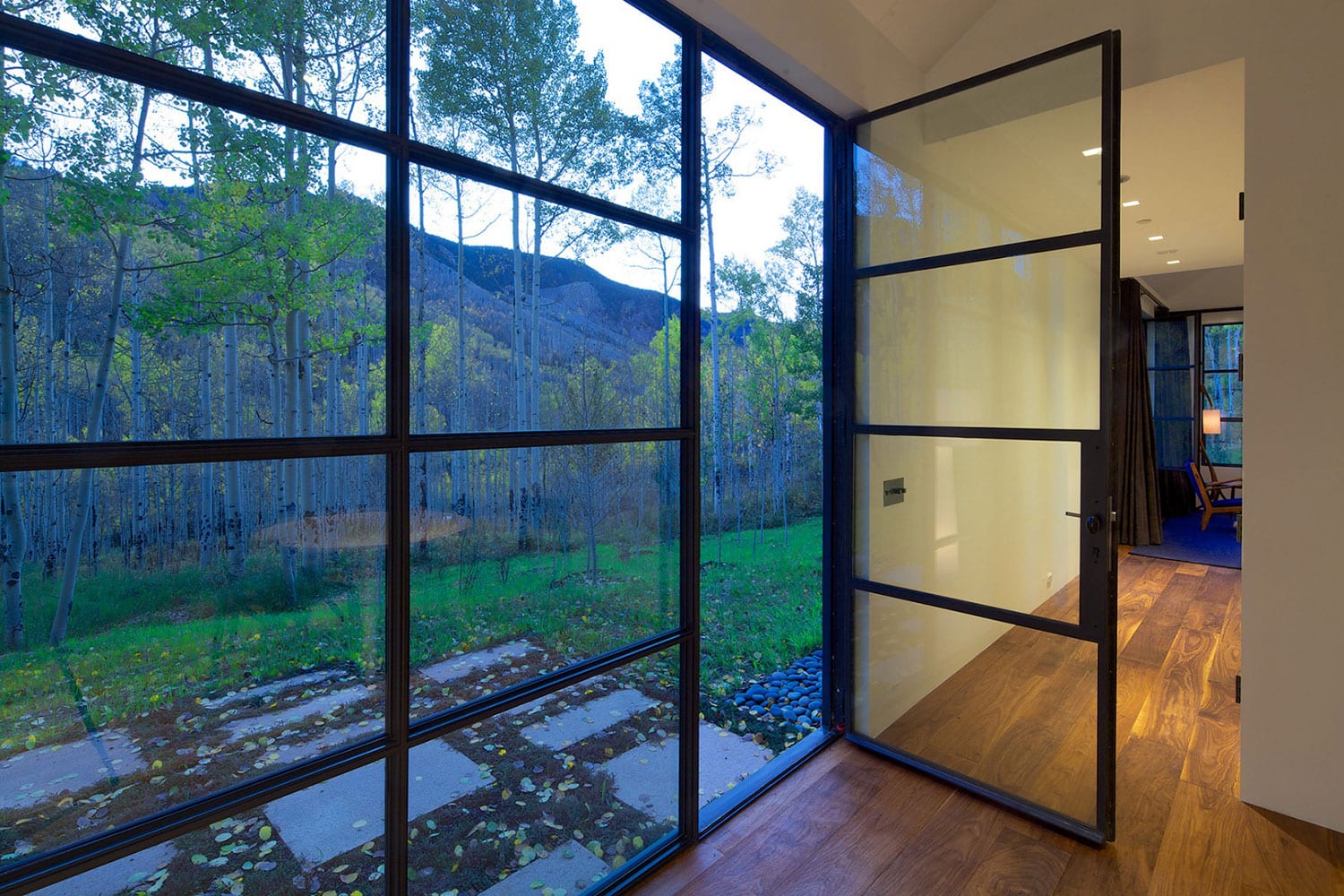 Glass door opening to the forest