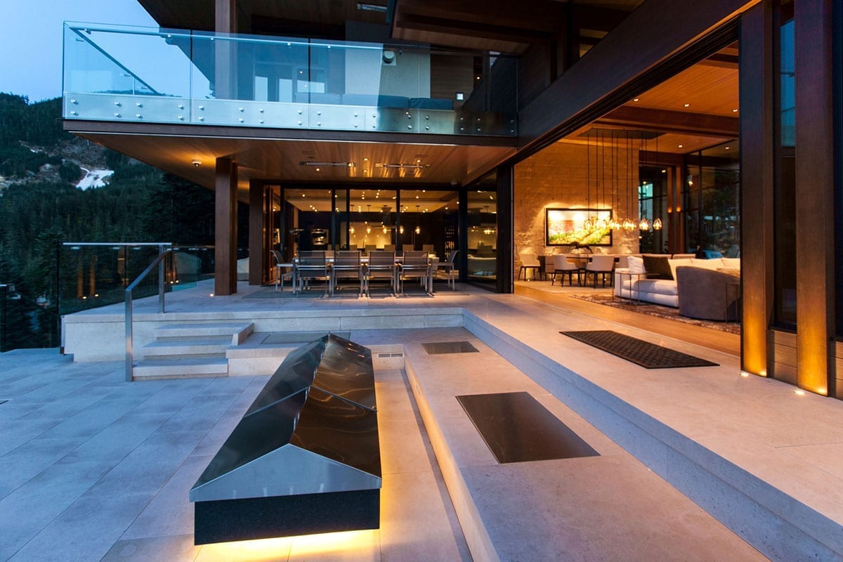 steel lift & slide doors open, exterior view looking into dining area at dusk