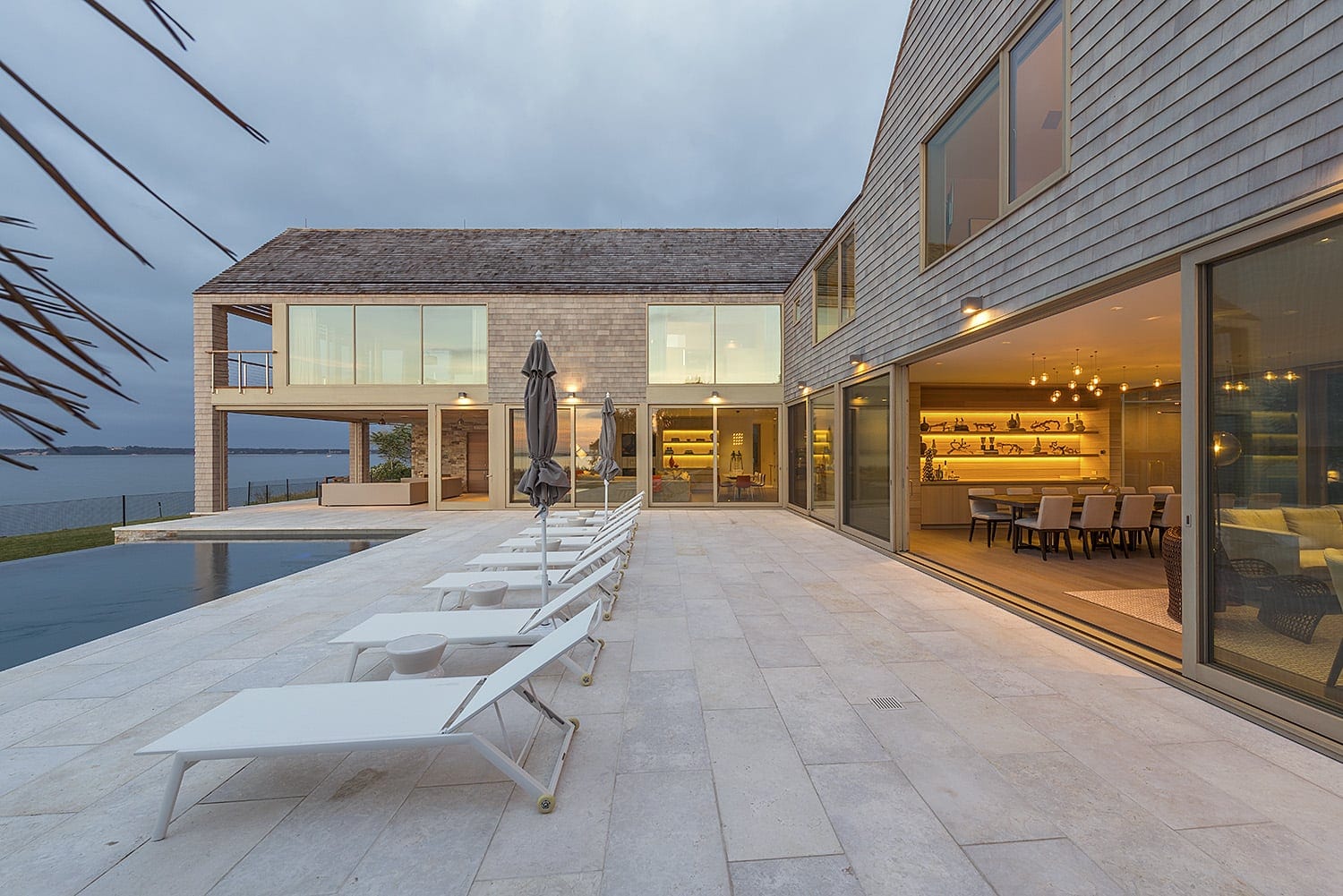 Large multi-panel wood lift & slide doors in home overlooking the sea