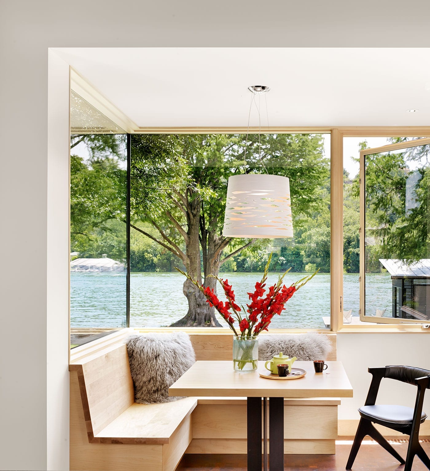 Corner wood storefront with integrated casement window in breakfast nook