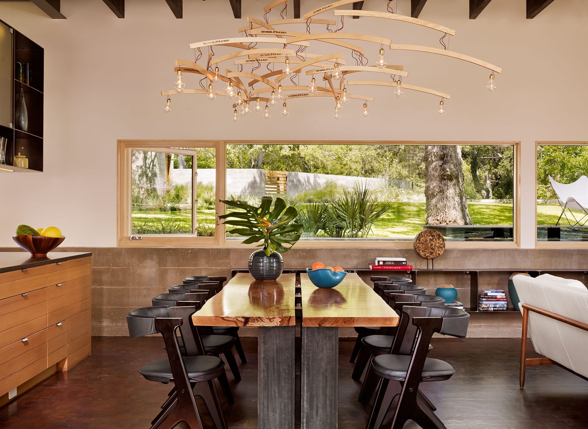 Horizontal wood storefront with integrated casement window in dining room