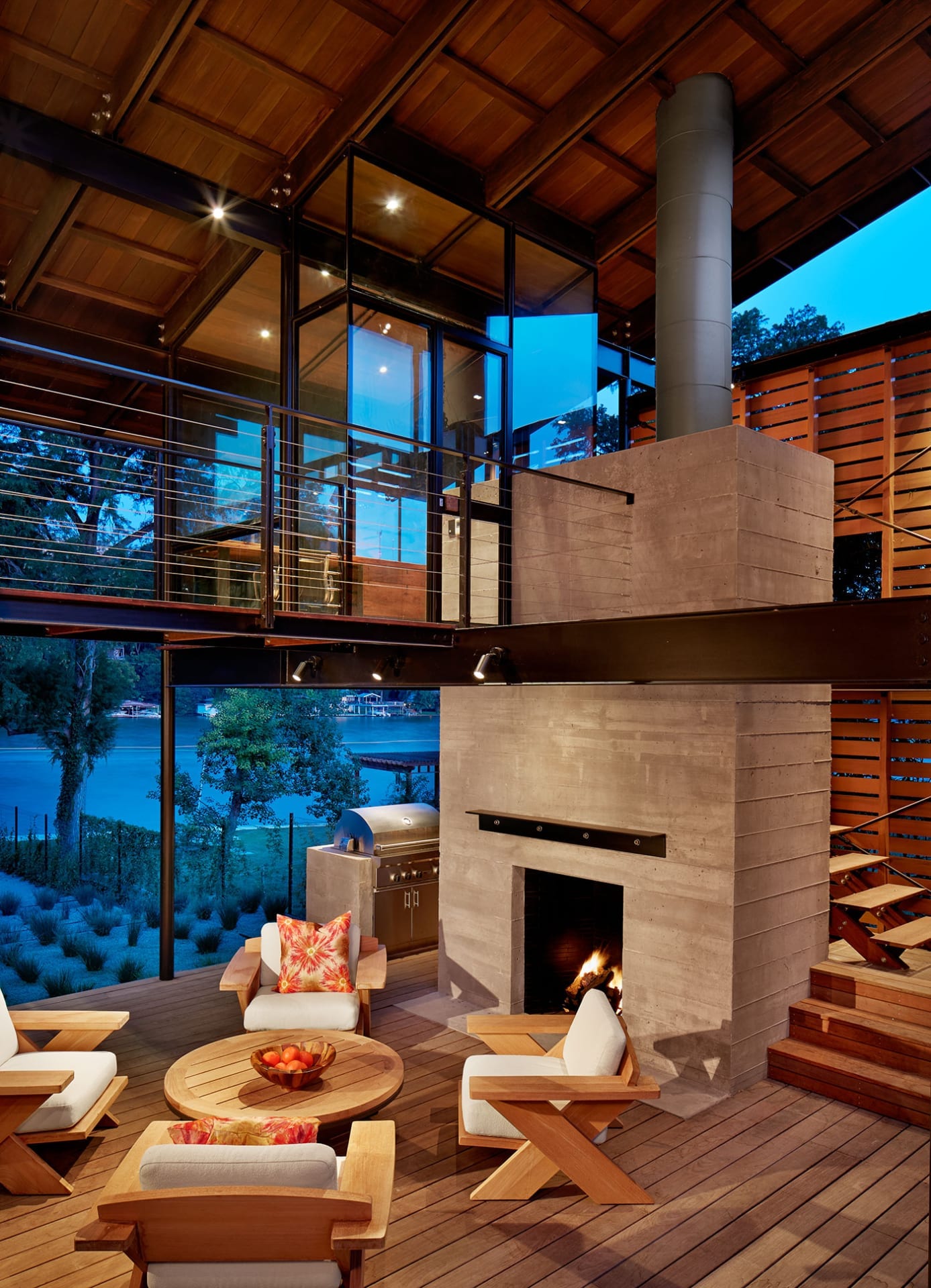 Two story fireplace and walkway overlooking the lake