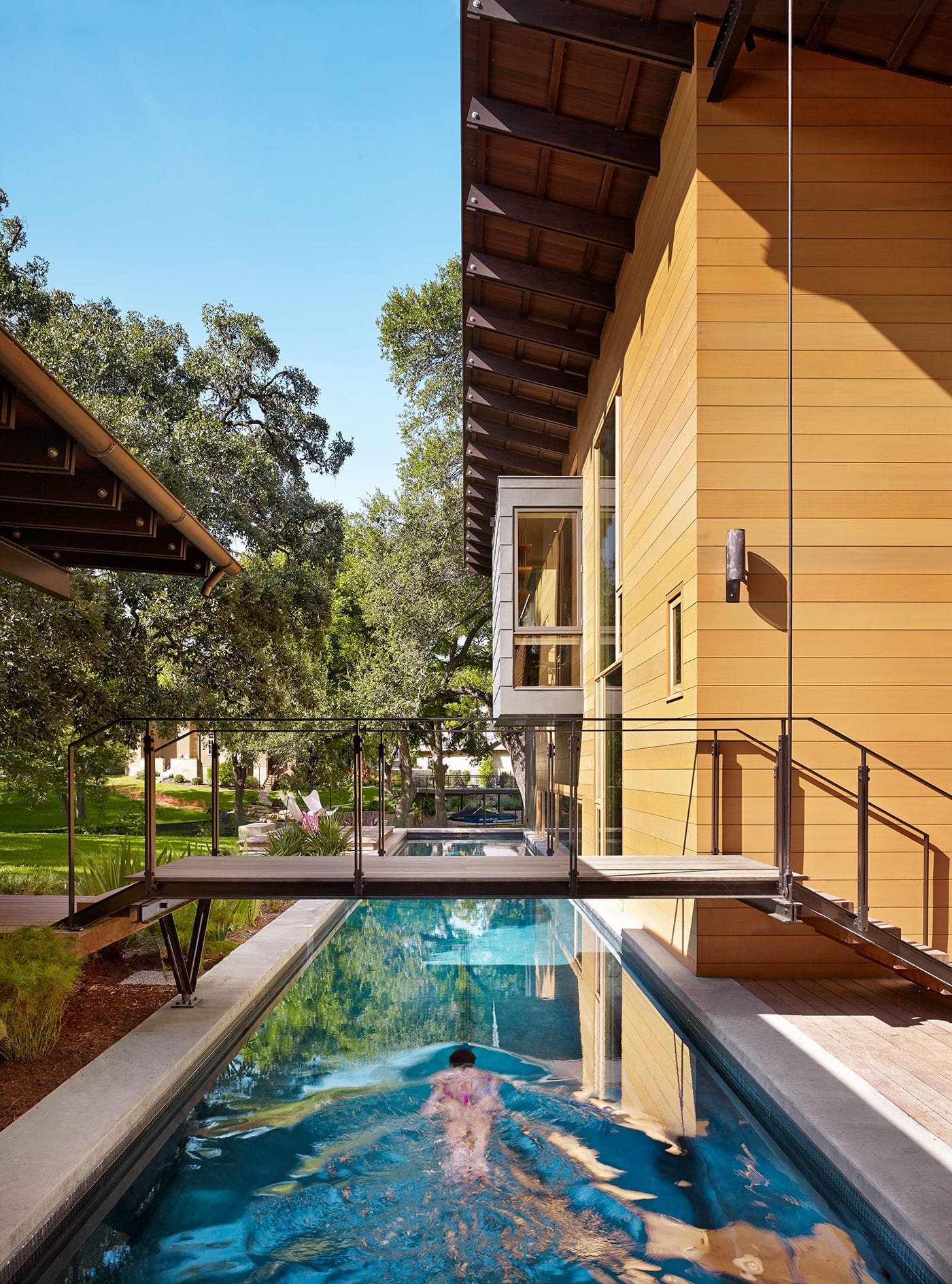 Lap pool with walkway and modern wood windows