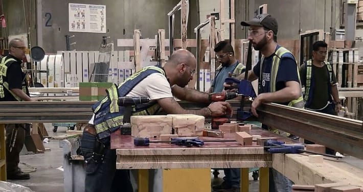 View of workers in metal window shop