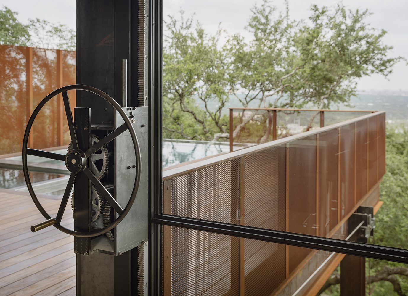 Hand operated wheel and exposed counterweights for vertical moving window