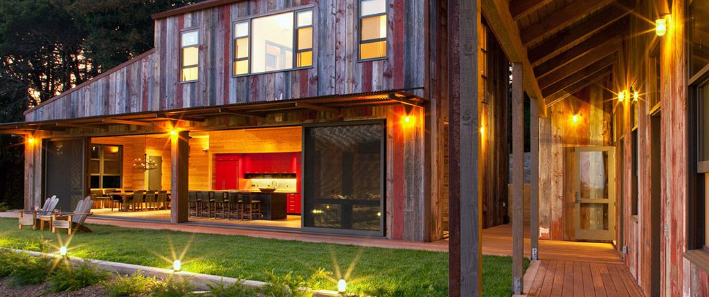 Modern rustic farmhouse at night